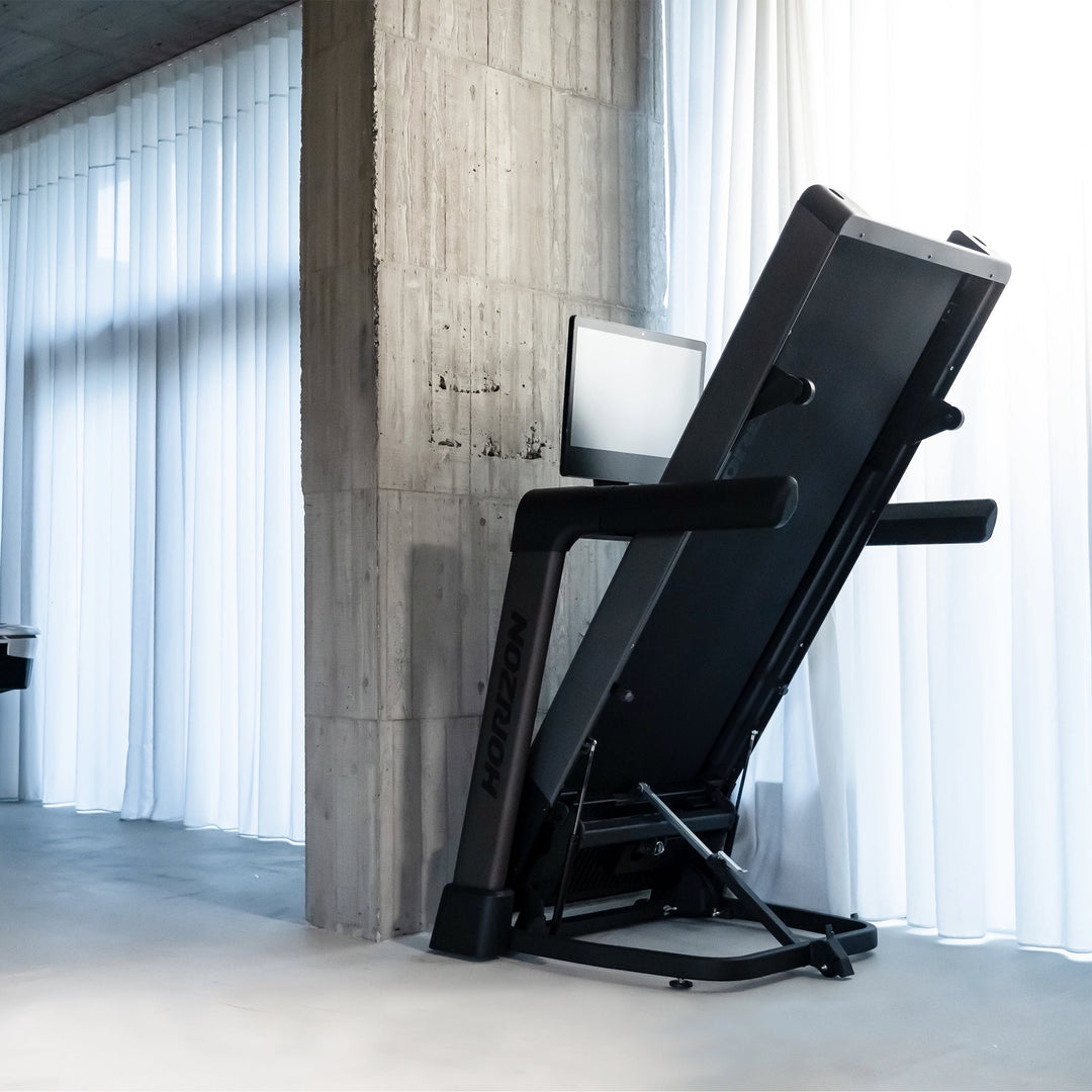 Folded Horizon Tread XP electric treadmill showing its space-saving design.